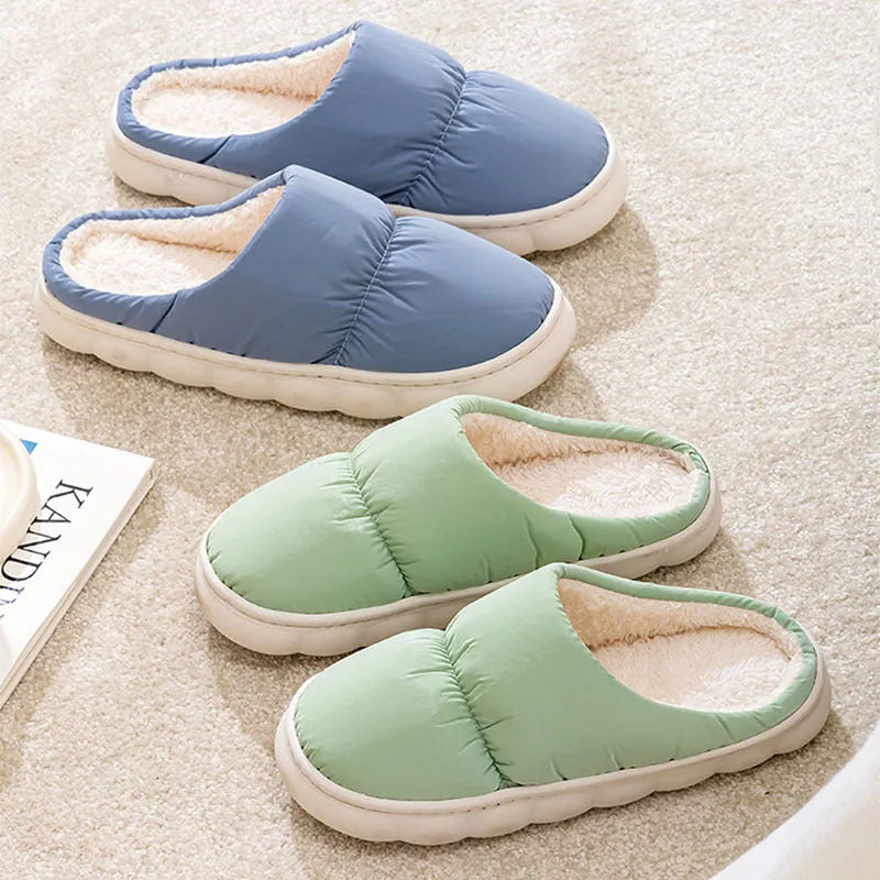 A pair of down cotton slippers with a thick rubber sole and artificial leather upper in a selected colour.