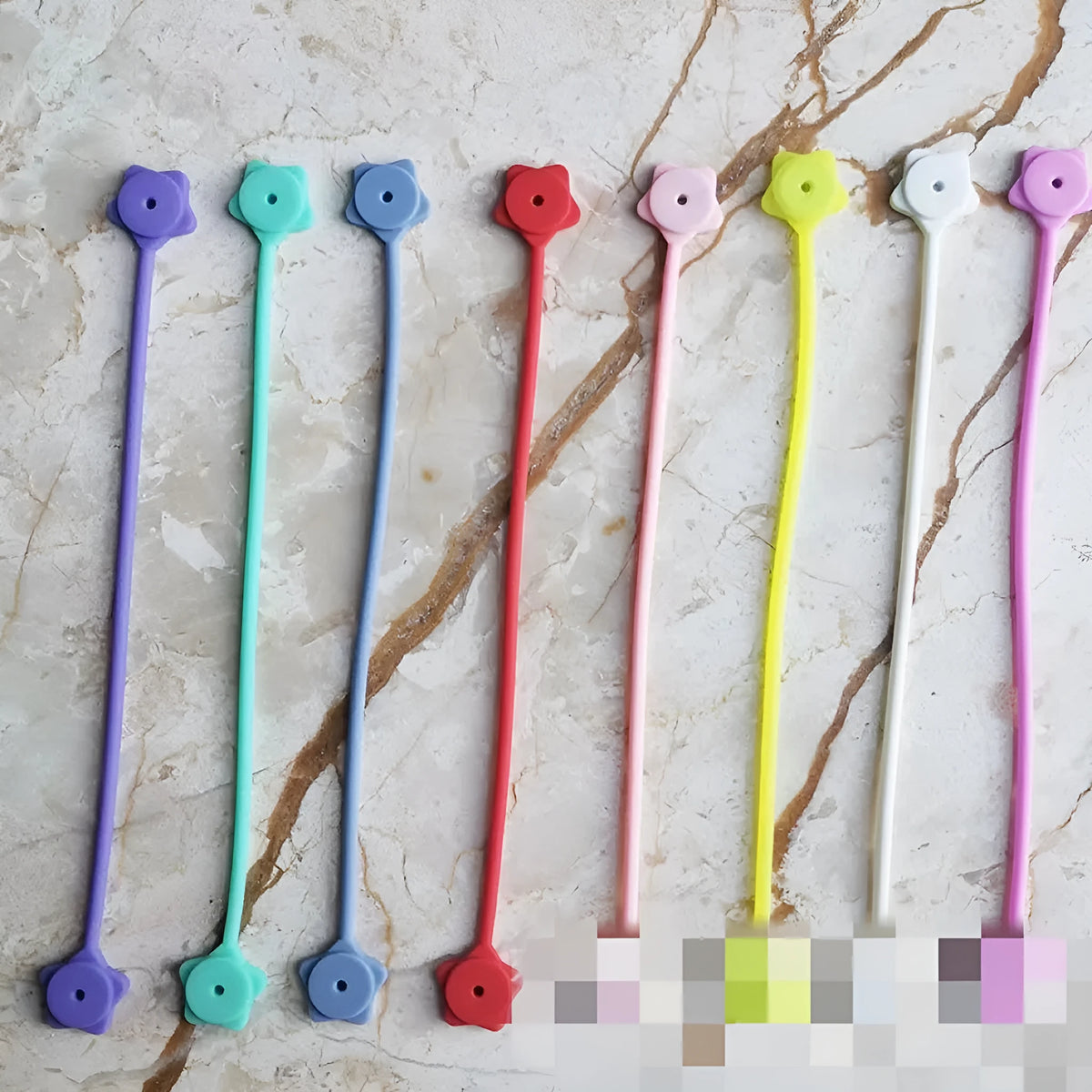 Purple star-shaped silicone wire winder with magnet for organising mobile phone and headphone cables.
