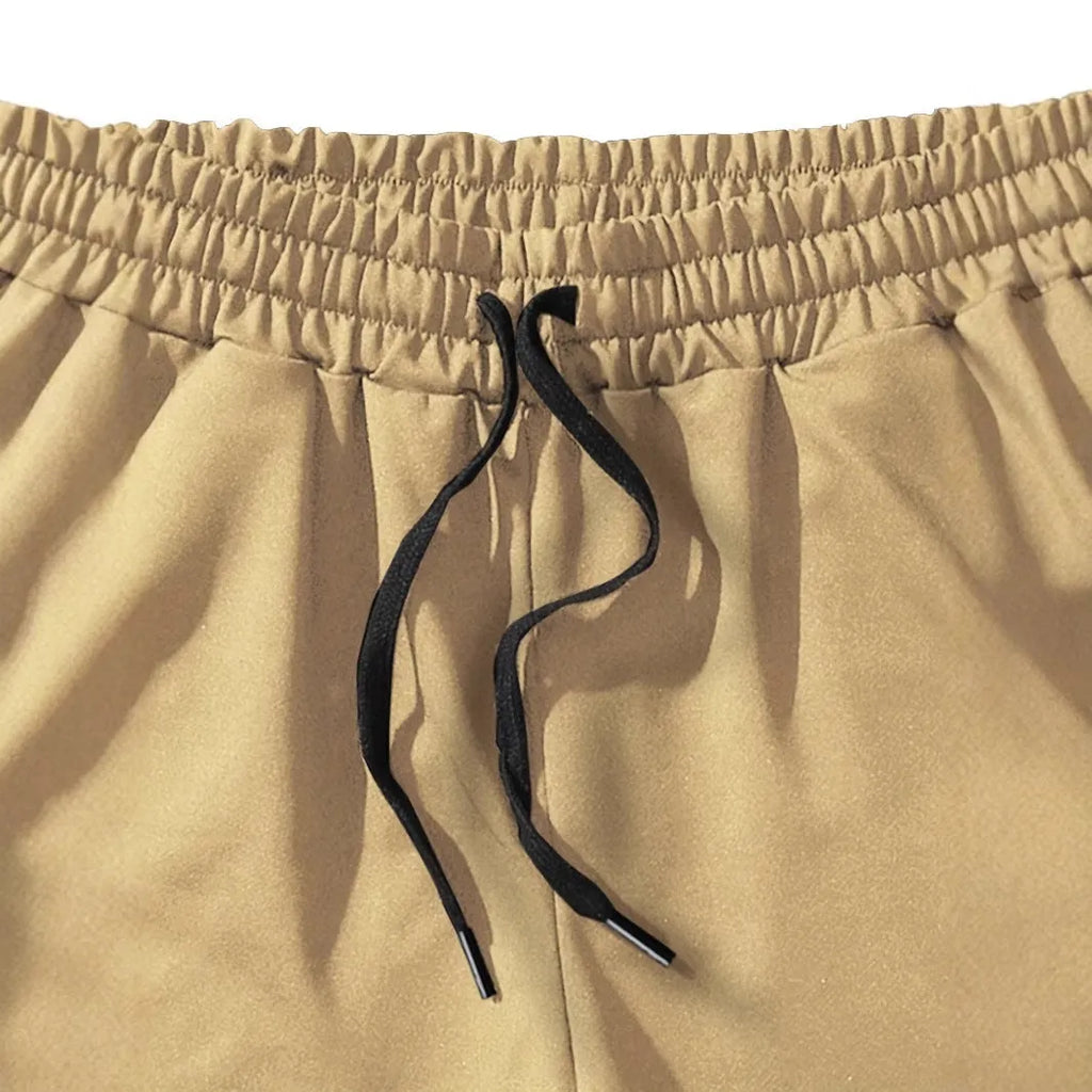 Man wearing khaki coconut print straight-leg sports shorts made of polyester