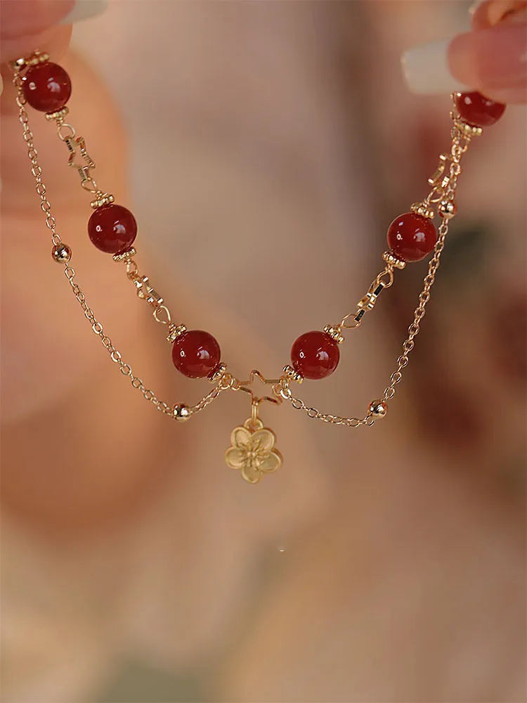 Red agate double layer bracelet for women with floral and peach blossom decorative elements.