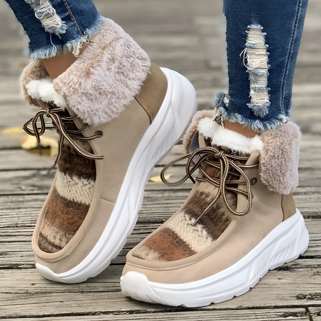 Women's beige lace-up snow boots with thermal lining and rubber sole on wooden surface