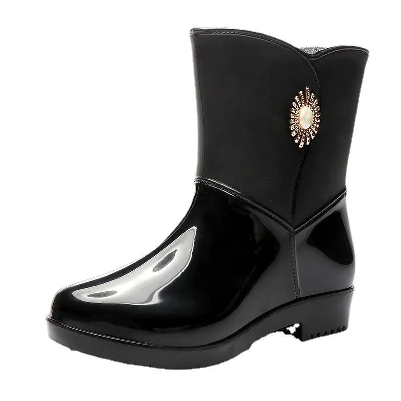 Women's purple PVC rain boots with a middle tube height and textured non-slip sole.