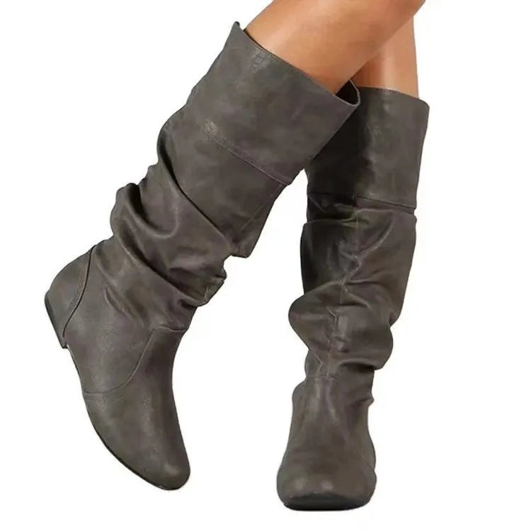 Women's flat heel slip-on ankle boot in artificial PU, shown in a solid colour with a round toe and high-top design.