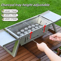 Small portable folding metal charcoal grill for outdoor barbecues.