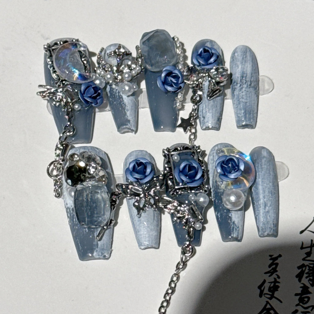 Blue night nail armour with ornate rose and tulip floral patterns in plastic evening manicure set