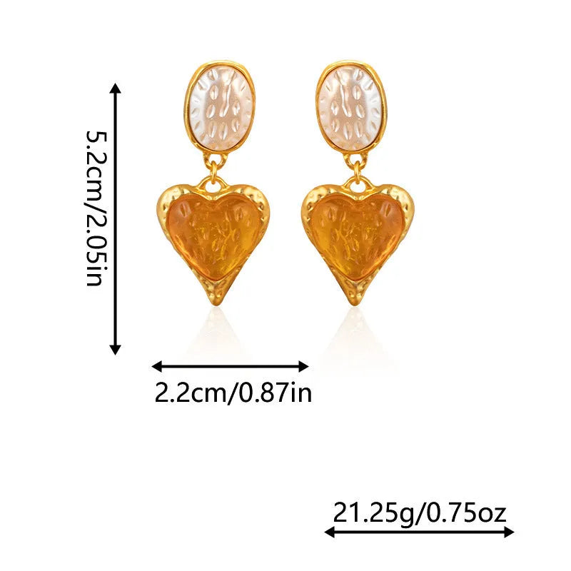 A pair of silver needle pleated oval love heart stud earrings in alloy metal, showing the textured surface and heart shape.