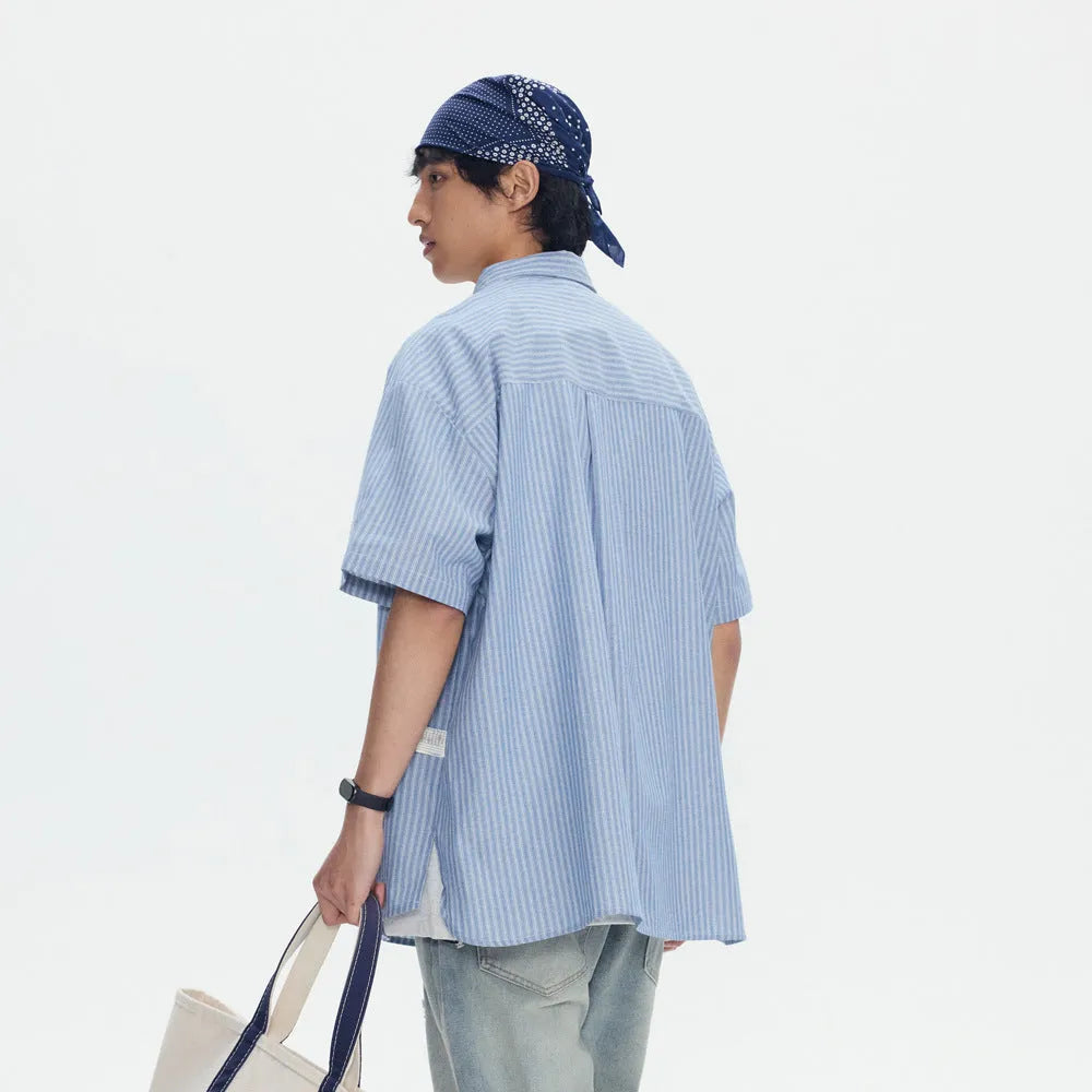 Blue striped loose short-sleeved shirt in cardigan style on a hanger