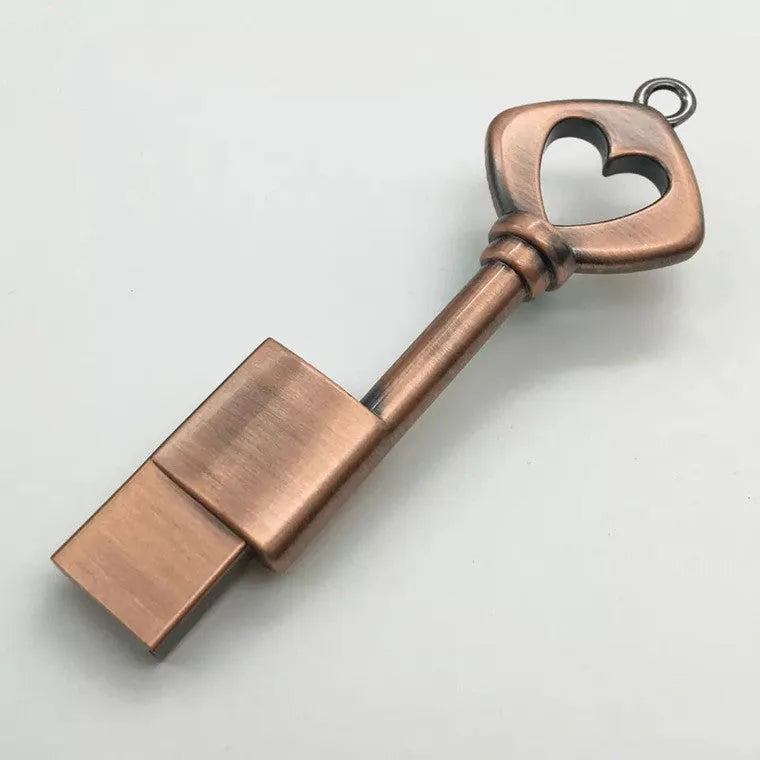 Heart shaped bronze metal USB flash drive pendant with USB 2.0 interface and write protection switch.