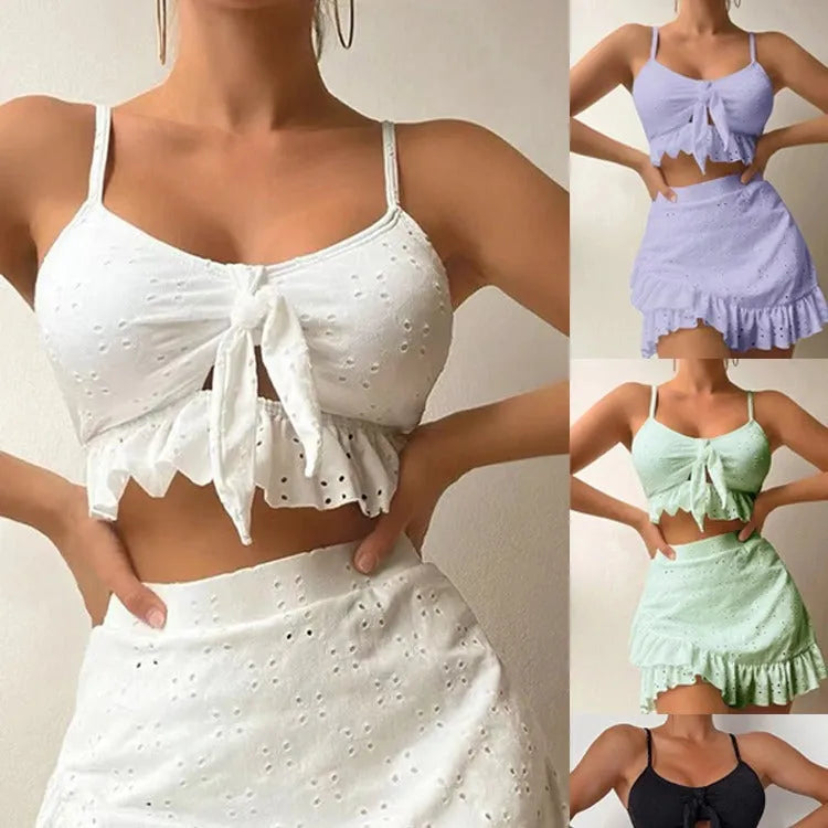 Women's white split-hip skirt swimsuit three-piece bikini on a mannequin.