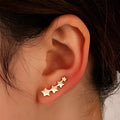 A pair of copper leaf-shaped clip-on earrings for women.