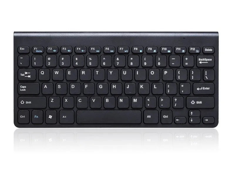 Black and white wireless keyboard and mouse set with USB receiver on wooden desk