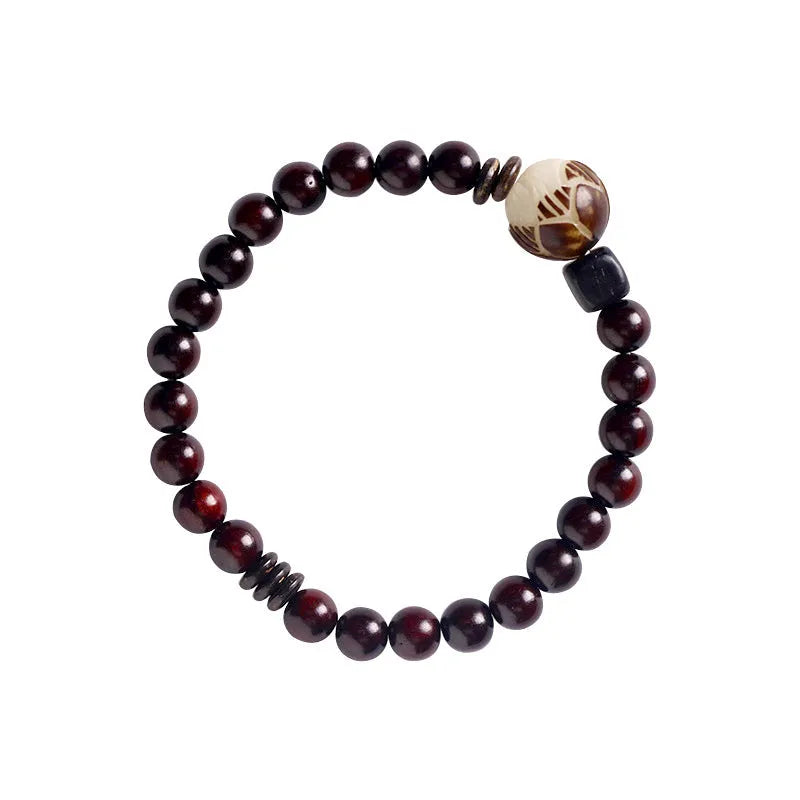 Rosewood bracelet with floral beads and circle pendant options on wooden background