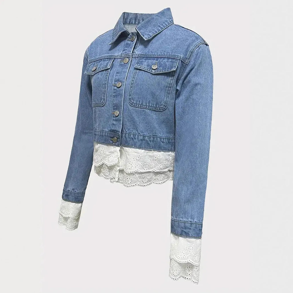 Blue women's denim jacket with decorative lace stitching on the front, long sleeves.
