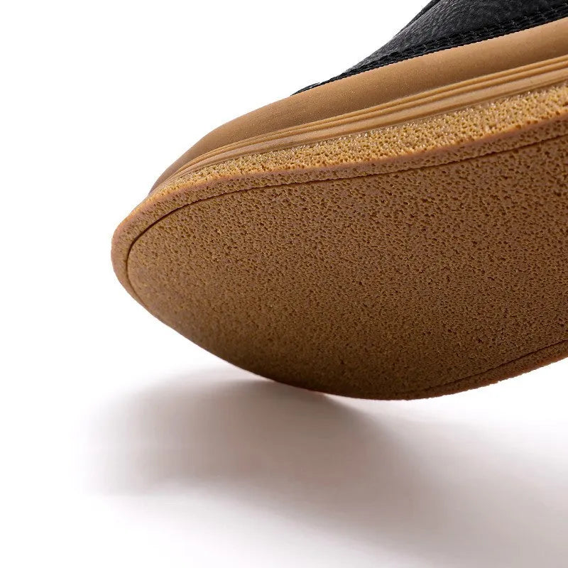 Men's black leather casual shoes with round toe and flat rubber sole on white background