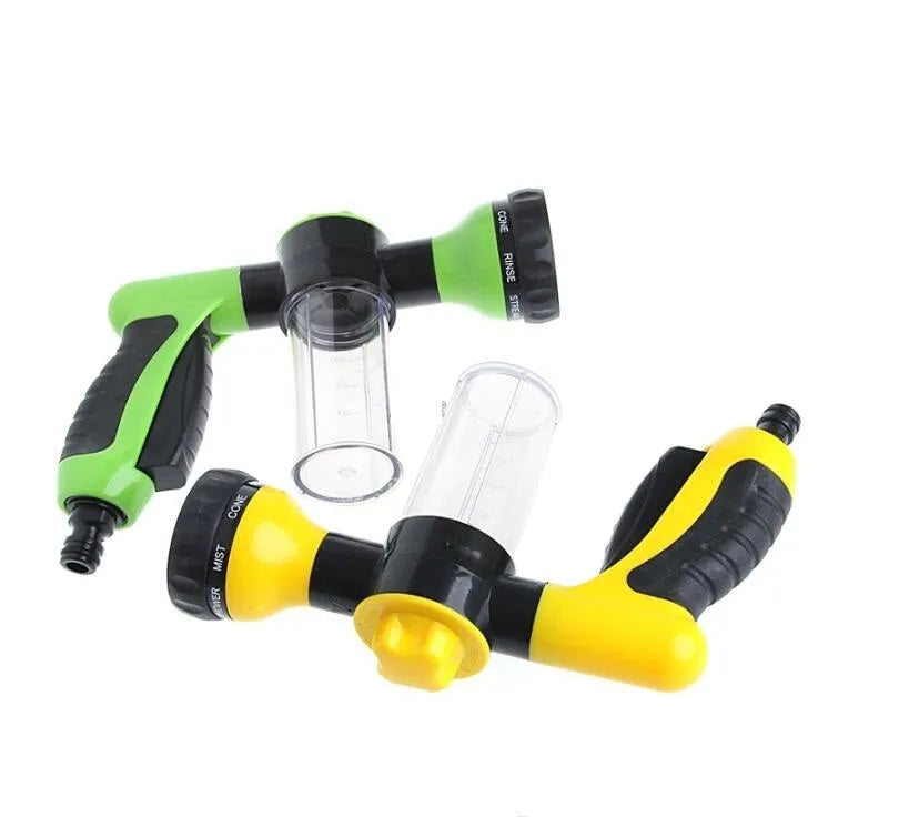 Green high-pressure foam spray gun with adjustable nozzle and attached water hose for car and garden cleaning.