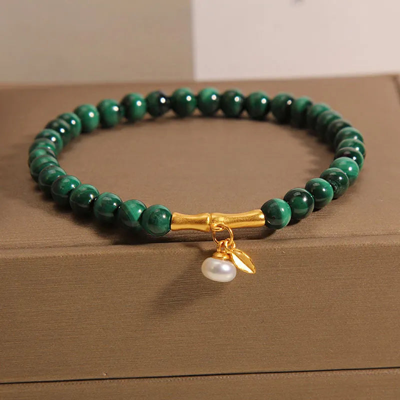 Close-up of a women's adjustable crystal bracelet with a white Lucky Bamboo design on wrist.