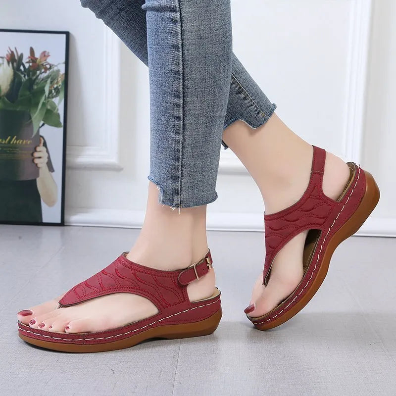 Women's casual wedge heel flip flop sandals with an adjustable buckle strap in solid colours.