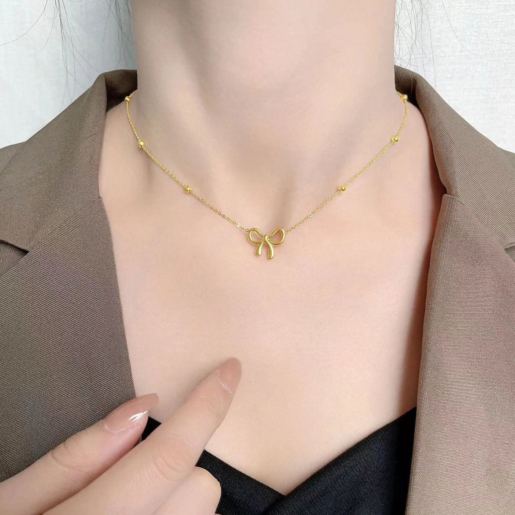 Gold electroplated bow necklace with titanium steel cross chain, adjustable 41-50cm length