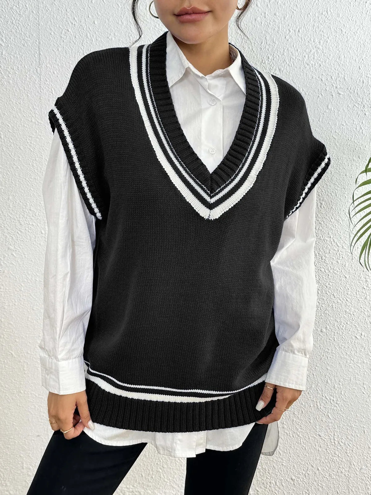 Loose fit blue women's vest sweater in college style, shown as a pullover on a hanger.