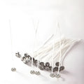 White cotton candle wicks in three lengths: 2.6cm, 6cm, and 8cm, laid out on a surface.