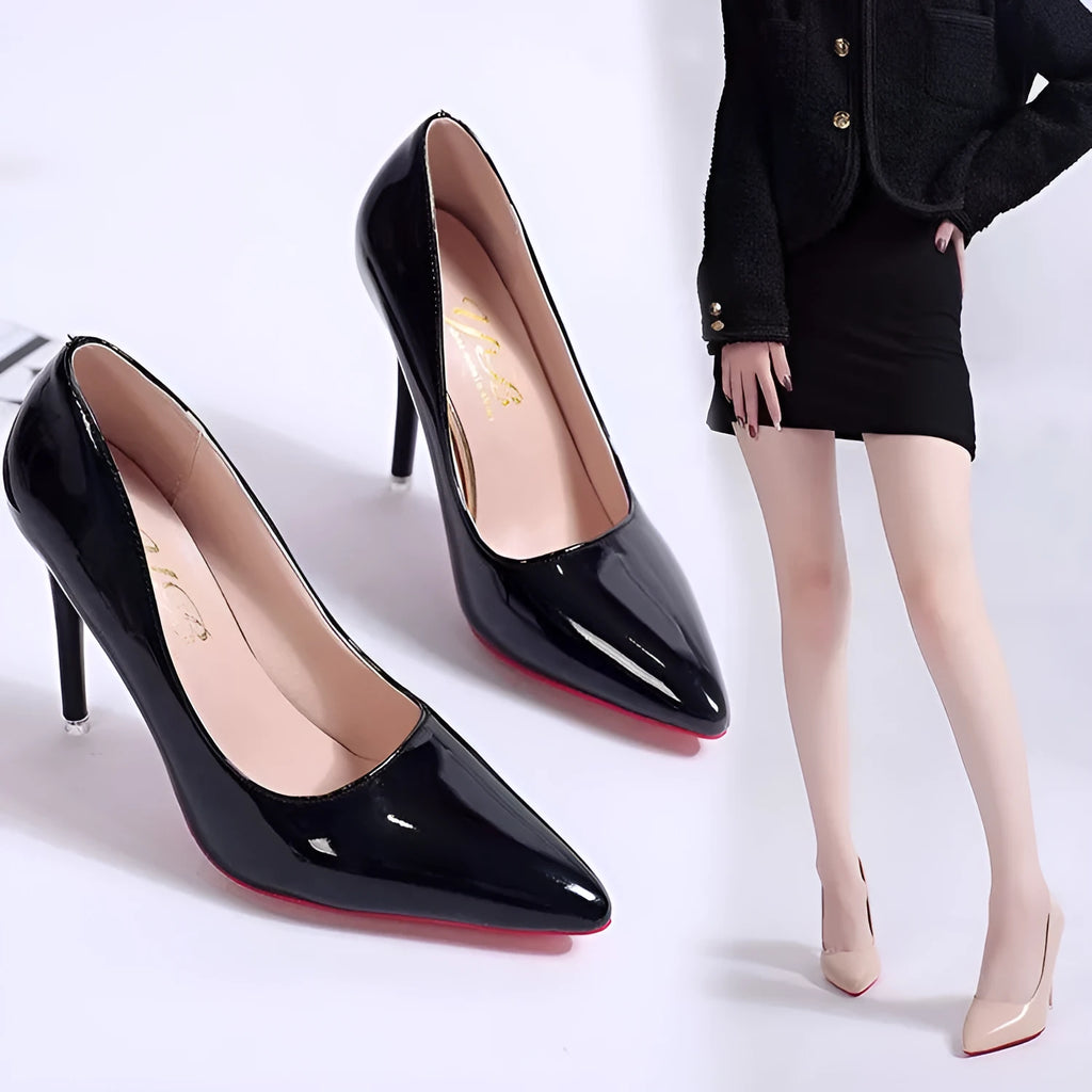Women's black pointed toe stiletto heel pump with a low top and rubber sole.