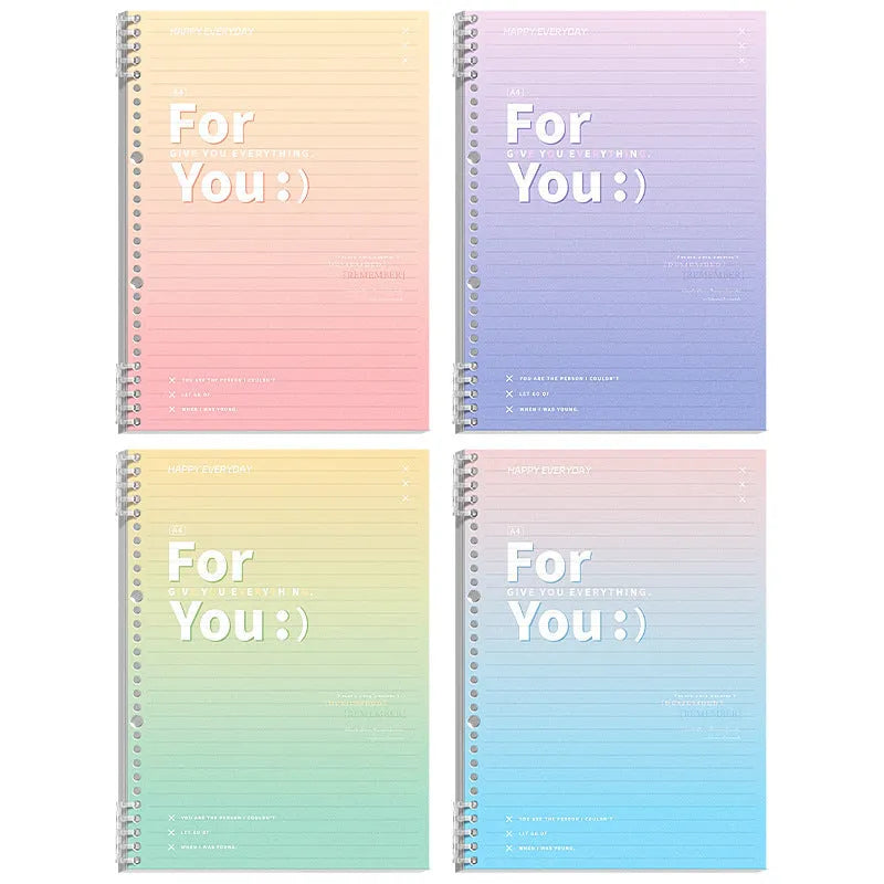 Removable coil-bound gradient colour notebook in A4 and B5 sizes on a desk.