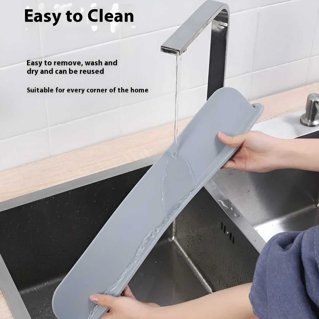 Thick grey silicone sink water blocking plate splash guard shown on a kitchen sink edge