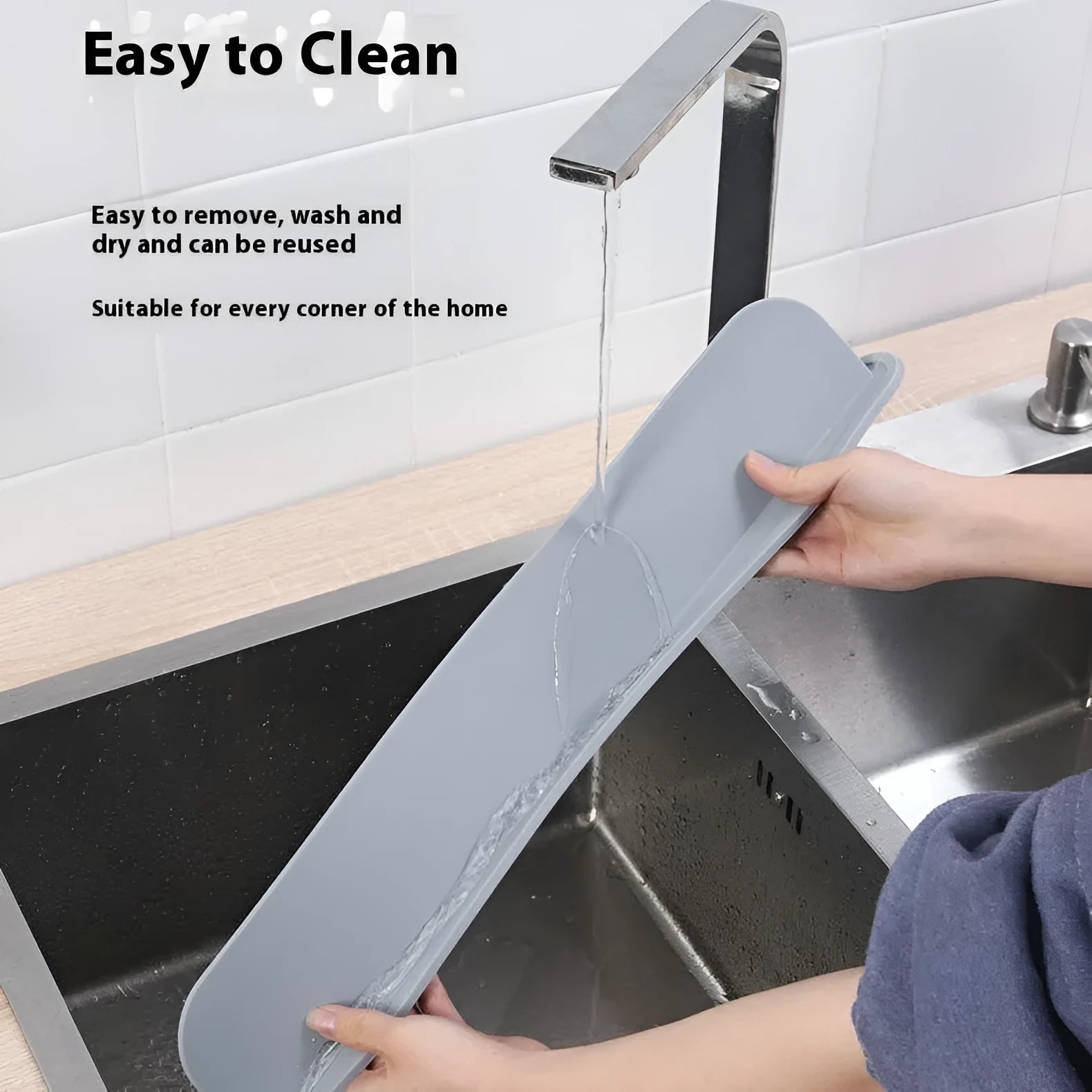 Thick grey silicone sink water blocking plate splash guard shown on a kitchen sink edge