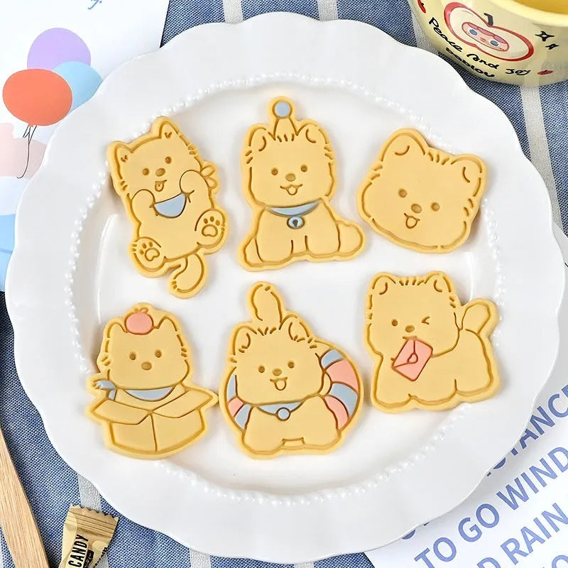 Plastic three dimensional biscuit mold with cartoon puppy designs including birthday hat style