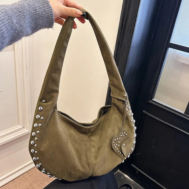 Soft plush casual tote handbag in a retro style, shown in a strapless underarm carry position.