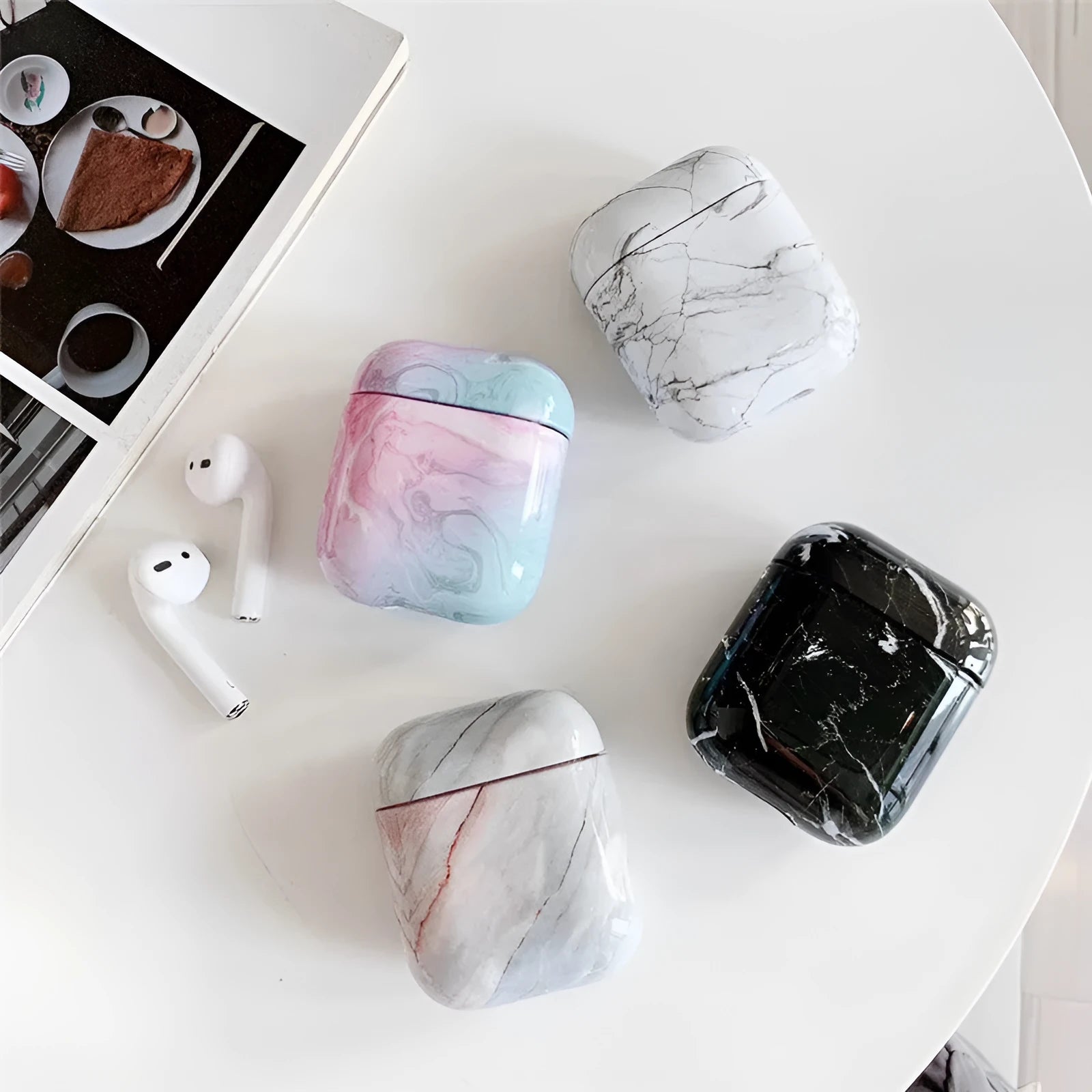 White marble pattern hard case covering an Apple AirPods charging box.