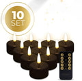 Four black LED tealight candles showing flameless illumination with battery compartment