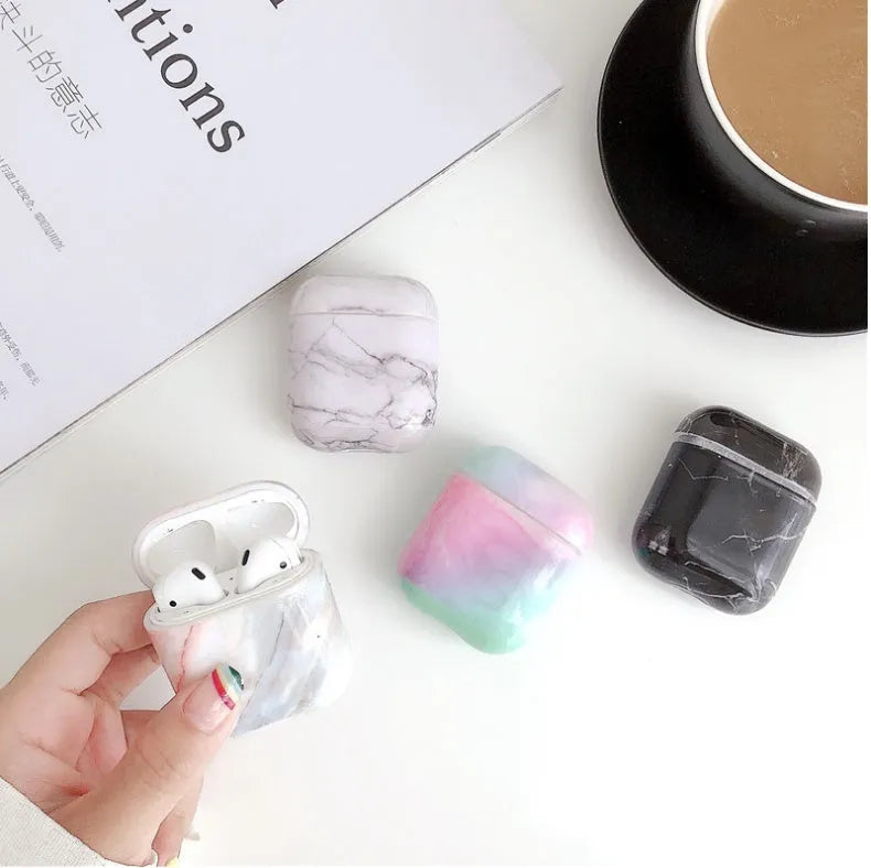 White marble pattern hard case covering an Apple AirPods charging box.