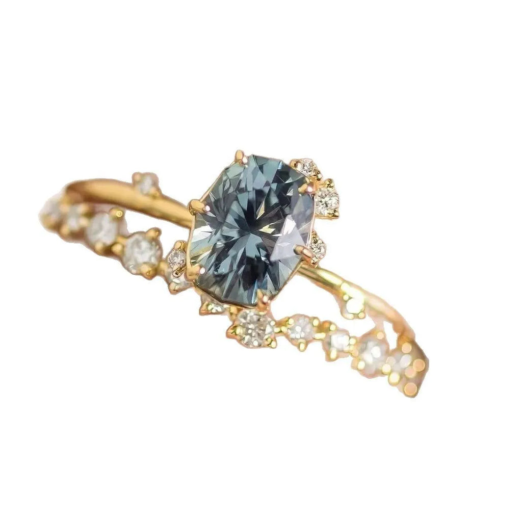 Gold plated flower-shaped ring with green zircon stone, shown in women's size.