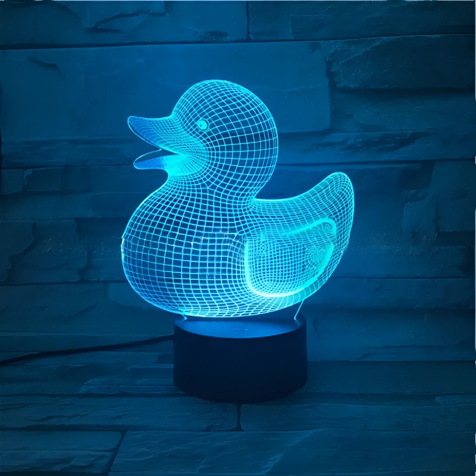 3D little yellow duck night light with colourful LED illumination on a table