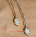 Oval S925 silver pendant necklace with a round jelly opal, shown in both gold tone and white gold tone finishes.