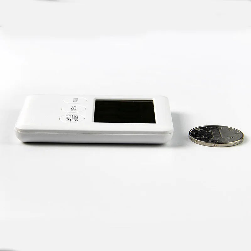 Black and white kitchen timer with magnetic back showing count-up and countdown functions