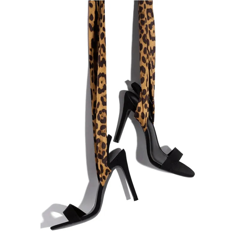 Light brown leopard print women's high heel sandals with criss-cross ankle straps and a pointed toe.
