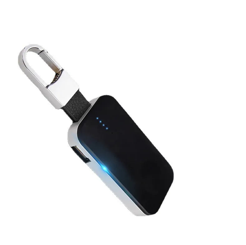 Black Apple Watch portable wireless power bank with keychain ring, shown next to an Apple Watch.