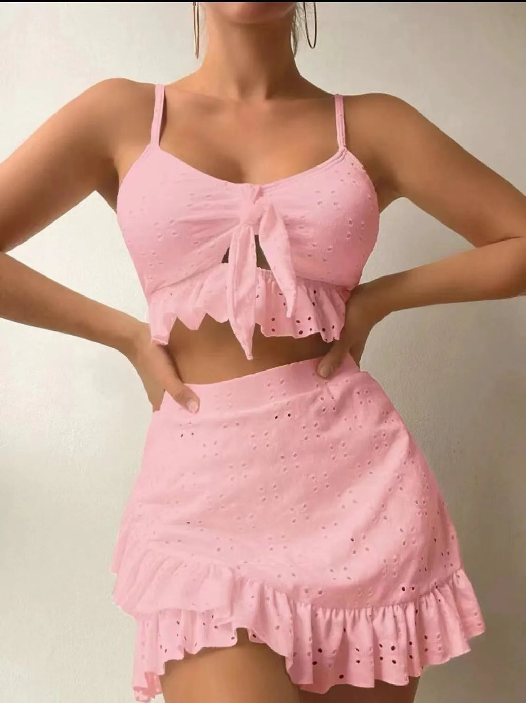Women's white split-hip skirt swimsuit three-piece bikini on a mannequin.