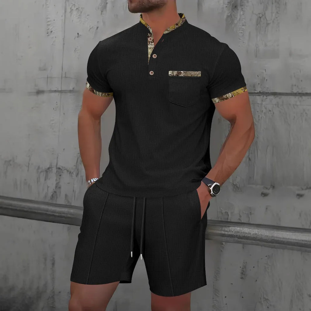 Men's grey zip-front polo collar short sleeve jacket and matching shorts set laid flat.