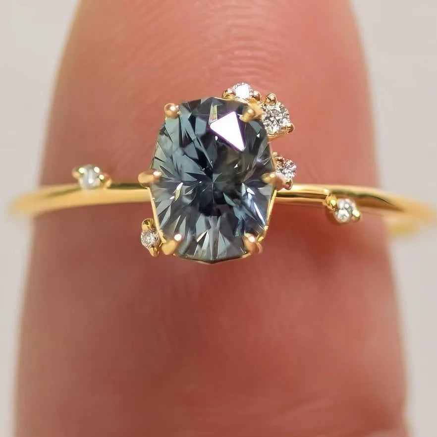 Gold plated flower-shaped ring with green zircon stone, shown in women's size.