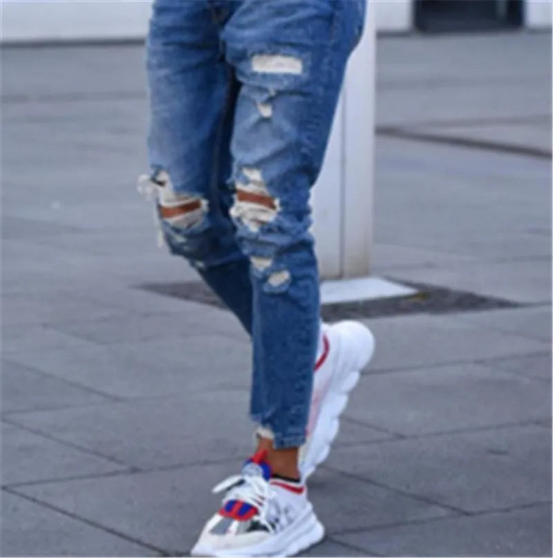 Men's deep blue cotton jeans laid flat, showing the five-pocket design and button fly.