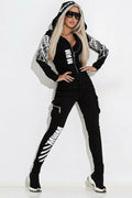Black women's casual suit with wings print on hooded top and trousers, front zipper detail.