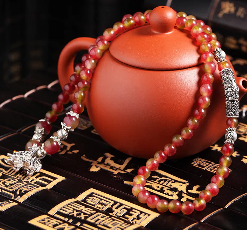 Handmade geometric bracelet made from natural watermelon crystal beads with Chinese knot closure.