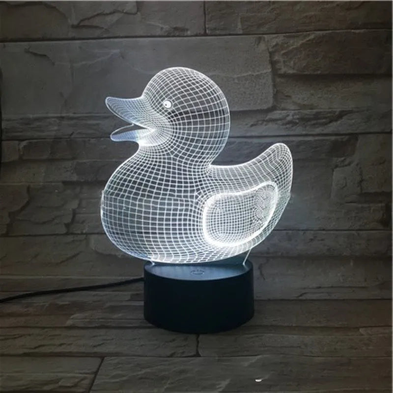 3D little yellow duck night light with colourful LED illumination on a table