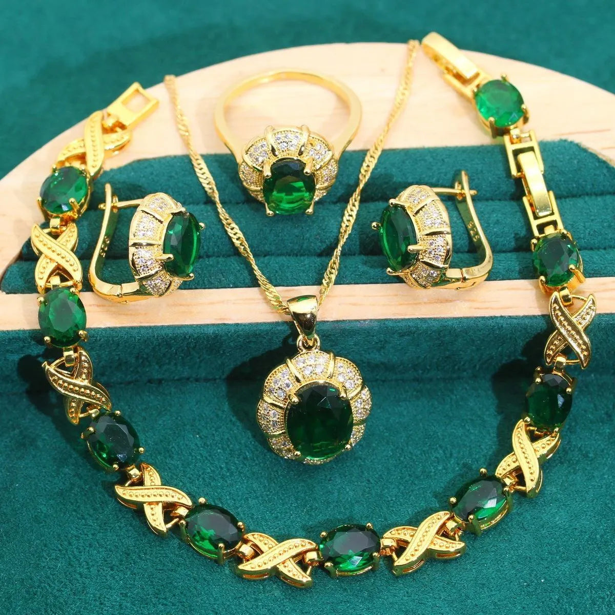 18k gold plated jewellery set with blue cubic zirconia stones showing necklace, earrings, ring, and bracelet