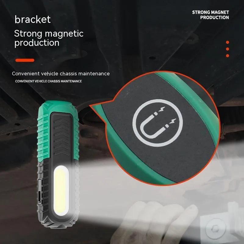 Black and green auto repair work light with USB charging port and drop-resistant coating