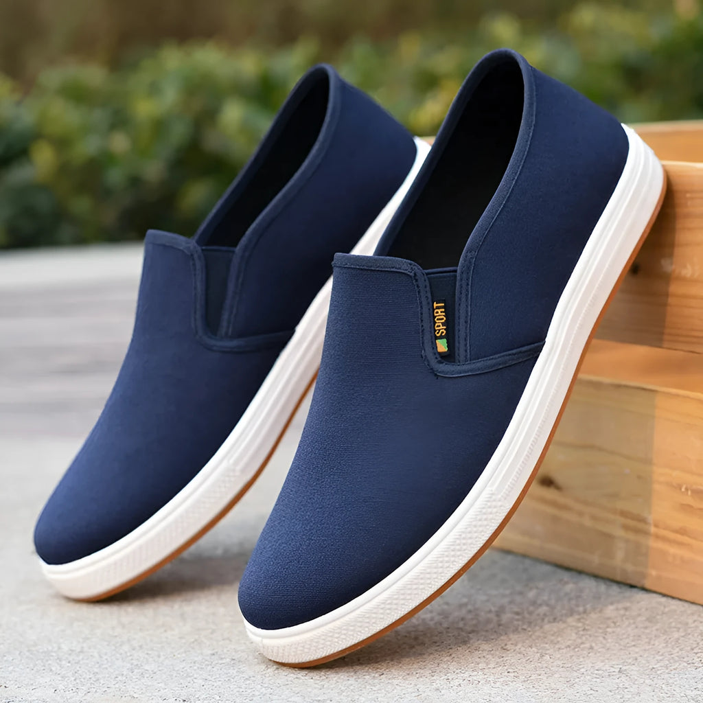 Men's black and blue canvas slip-on shoes with round toe and low-top design on composite sole