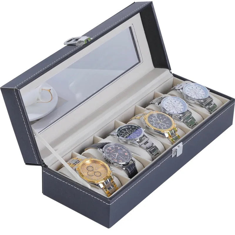 Grey leather watch storage box with transparent lid showing watch cushions inside.